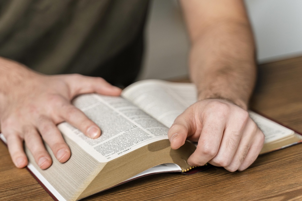 man-reading-from-bible-table